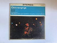 Front cover of the vintage Stan Getz vinyl record album "Getz Au Go Go" showing the title, artist, and a photo of Stan Getz playing saxophone with a faded and worn look.