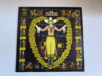 Front cover of "Sweetheart of the Rodeo" vinyl album by The Byrds, showing colorful western themed artwork of a woman in cowboy attire inside a floral heart.