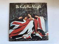 Front cover of The Who's 'The Kids Are Alright' album depicting band members wrapped in a Union Jack flag.