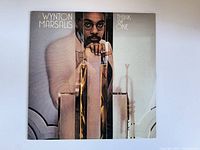 Front cover of Wynton Marsalis vinyl album featuring an artistic portrait of the artist with muted colors and trumpet elements.