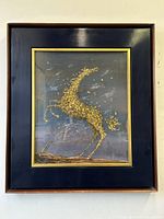 Frontal view of painting in black wooden frame with gold inner lip, hung on wall.