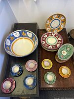Overhead shot of entire set showing serving bowl, plates and teacup sets arranged on tables