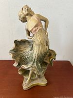 Full view of the standing dancing girl terra-cotta sculpture showing pose and dress details.