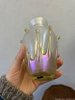 Front side view of the iridescent Aurene glass vase showing applied glass drips and smooth frosted neck.