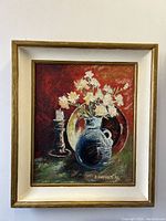 Front view of framed oil painting with floral still life by artist E. Lindholm, signed and dated 1941.