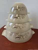Stacked set of the four Pyrex Forest Fancies nesting mixing bowls showing the pattern and nesting arrangement