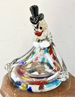 Front view of Murano art glass clown bowl showing detailed clown face, colorful embedded swirls, and black top hat