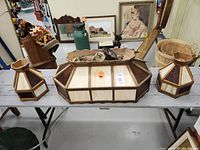Full view of all three stained glass lamp pieces on a table showing central large fixture and two smaller side fixtures.