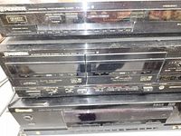 Close-up of the front panels showing model names and buttons of the tuner, cassette deck, and receiver.