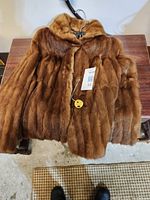 Front view of brown mink jacket showing plush fur and classic collar.
