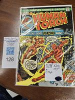 Full front cover of Human Torch #1 comic in plastic sleeve showing the colorful superhero action and title.