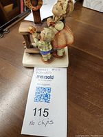 Image of the figurine showing the girl and boy beside a piano or organ, with a MaxSold tag indicating 'no chips'.