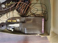 Vintage telegraph signal equipment with 'CODEMASTER' label, wires, and spool.