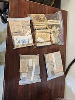 Four clear plastic bags each filled with assorted wooden stamp blocks with various sayings and designs, showing the overall contents of the lot.