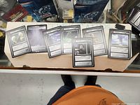 Several Yu-Gi-Oh! cards spread out showing various card types such as Instant and Dilemma with text and graphics.