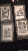 Photo of four baseball cards featuring Satchel Paige, Ty Cobb, Casey Stengel, and Cy Young in black and white from 1993 Hoyle Products series.