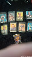 Football player trading cards displayed on black surface showing multiple players including Junior Wren, Charlie Conerly, Pete Retzlaff, Jim Ray Smith, Jerry Norton, Jim Mutscheller, Andy Robustelli, and Buddy Dial.