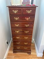 Front view of full dresser showing seven drawers, brass hardware and overall finish
