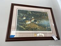 Full view of framed print showing wood ducks by Robert H. Cates, including frame, mat, and the gold seal on the mat.
