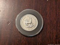 Obverse side of the Krugerrand commemorative silver coin showing the springbok antelope and text 1967-1982