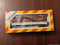 Front view of Lionel Canadian National train car in original packaging, showing the brown and white train car with CN markings.