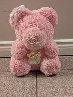 Front view of pink rose teddy bear showing detailed rose petals, bow, and crystal rose accessory.