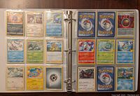 Open binder showing two pages filled with sleeved Pokemon cards in good condition.