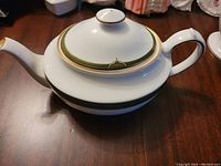 Side view of Spode Chardonnay teapot showing handle and spout with detailed green and gold trim.