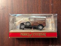 Front-side view of the Matchbox Models of Yesteryear vintage delivery van inside its clear display case, showing detailed signage and paintwork.