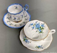 Both teacup and saucer sets together showing overall condition and detail