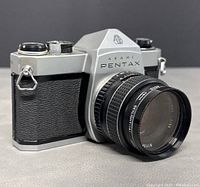 Front right angle view of Asahi Pentax film camera with 55mm f/2.5 lens attached showing body, grip, and lens details