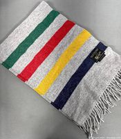 Light grey cashmere scarf with multicolor stripes and fringed edges, label showing Hudson Bay Company, Johnstons of Elgin, made in Scotland.