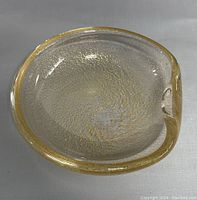 Top view of clear glass bowl with gold fleck swirl pattern and slight lip
