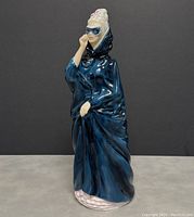 Front angle view of the Royal Doulton Masque figurine showing flowing blue cloak and masked face.