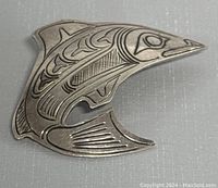 Front view of the vintage sterling silver brooch showing the detailed Northwest Coast Indigenous art design with animal motif.