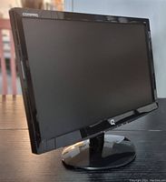 Front angled view of the Compaq 18.5 inch LCD monitor showing the screen, glossy black frame, and stand.