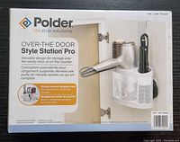 Front of the box showing Polder brand Over-The-Door Style Station Pro with image of the organizer holding a hair dryer and styling tools.