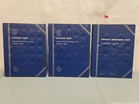 Three blue Whitman albums arranged side by side, titled for Lincoln Cent collections spanning 1909 to 1959.