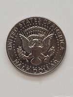 Reverse side of the 1973 Kennedy Half Dollar coin showing the Presidential Eagle seal and inscriptions.