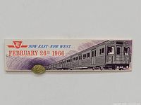 Front view of subway token mounted on card featuring subway train illustration and date February 26, 1966.
