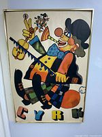 Full frontal image of the vintage Cyrk clown poster showing vibrant colors and framed in simple gold metal.