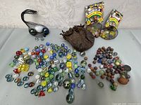 Full lot with all marbles, dice, and bags displayed on table.
