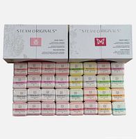 Five boxes of Steam O Originals shower steamers with 16 individually wrapped cubes inside each box, displayed in front of boxes showing variety and blends.