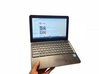 Front angled view of Acer 12.5 inch Chromebook laptop powered on, showing screen with YouTube trending page and keyboard.