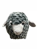 Closeup of grey patterned sheep plush toy
