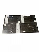 Four Logitech K380 Bluetooth wireless keyboards in sealed retail boxes laid out side by side on a white background.