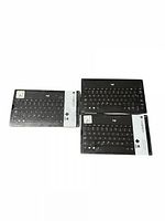 Three Logitech Slim Bluetooth Keyboards in original packaging, displayed together on white background.