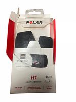 Front of the box with Polar H7 heart rate sensor visible inside packaging, showing brand, Bluetooth logo, and key product features