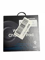 Front view of sealed box showing Samsung Wireless Charger Pad 2018 model with product image, Qi certification mark, and year 2018.