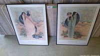 Two framed G.E. Mullan prints leaning on a couch, showing both artworks side by side.